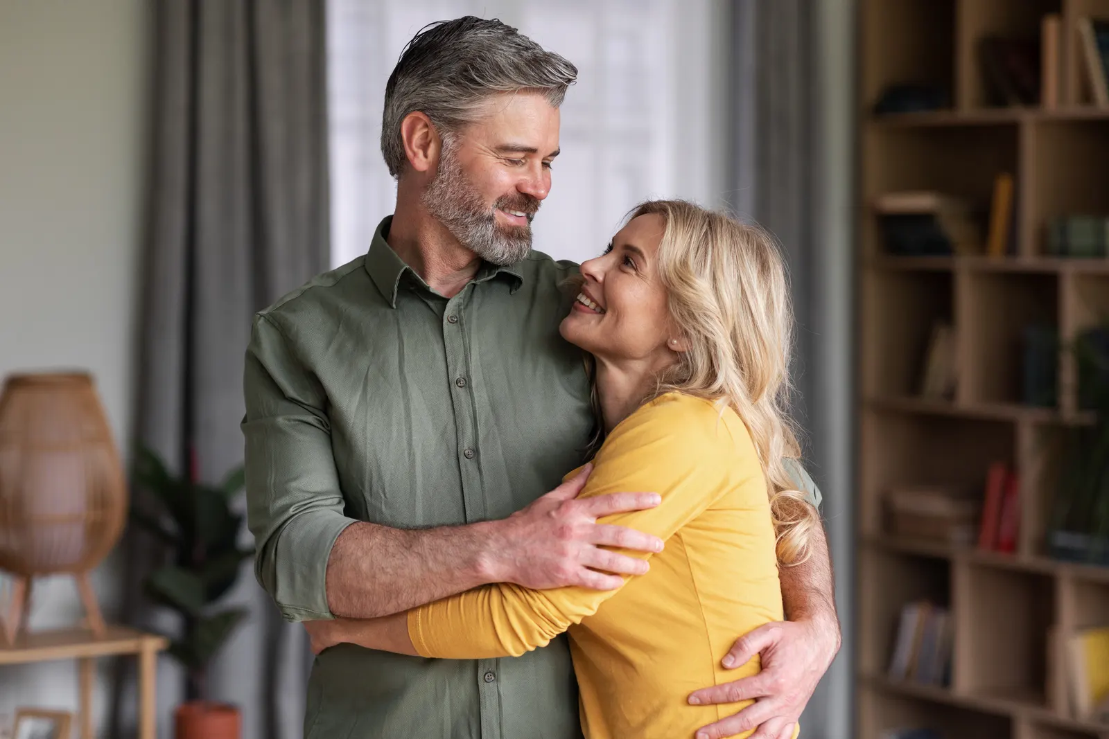 Couple embracing at home in natural light